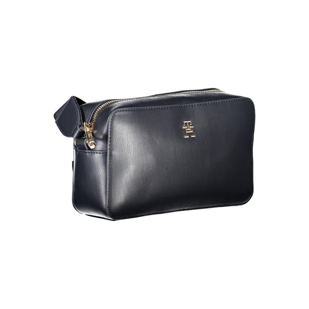 Tommy Hilfiger blue polyethylene women's handbag with gold logo and zipper, featuring an adjustable strap for versatile style.