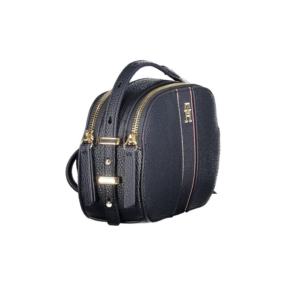 Tommy Hilfiger blue handbag with adjustable shoulder strap, dual compartments, zip closure, and embossed logo, perfect for stylish women.