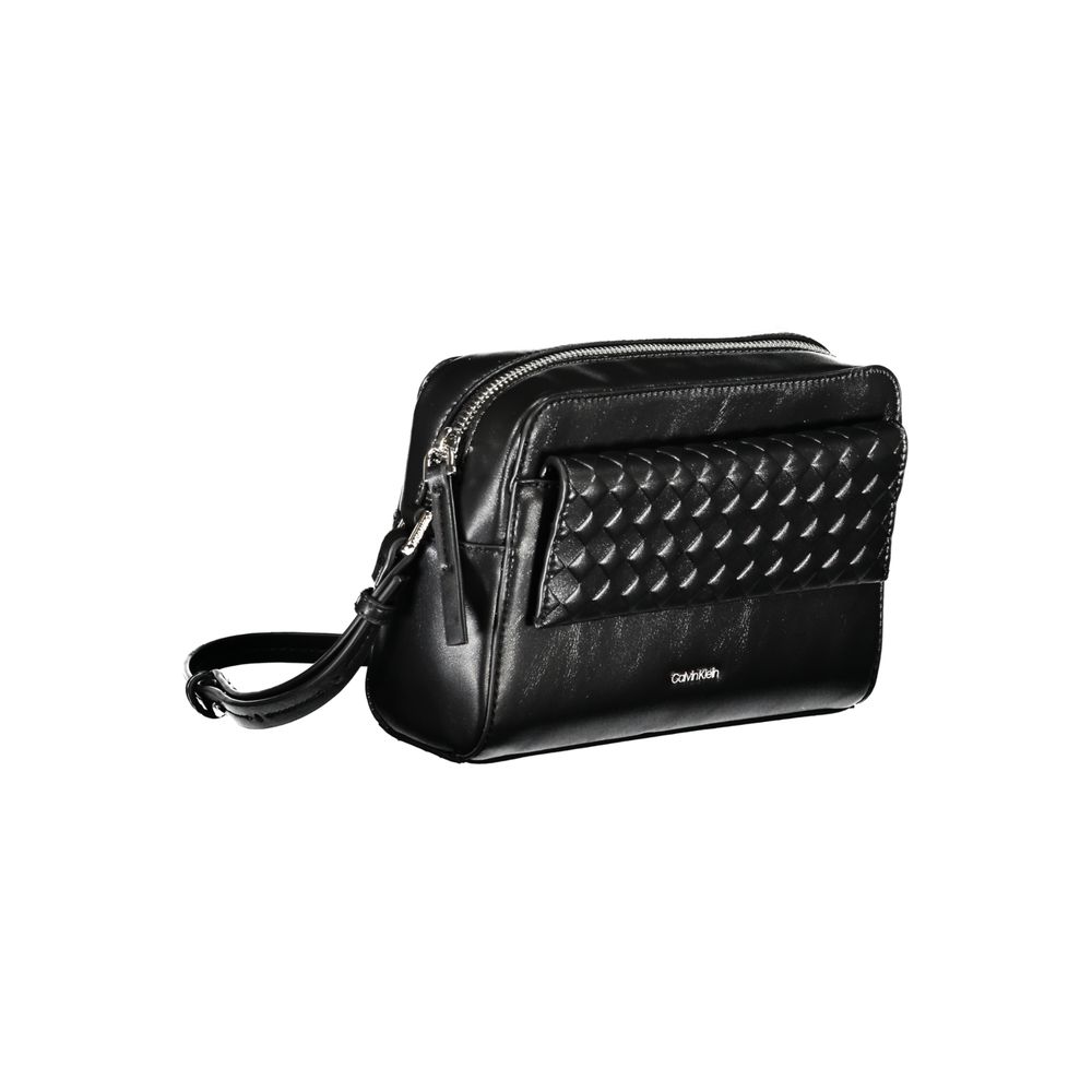 Calvin Klein Black Polyester Handbag with adjustable shoulder strap and contrasting details, featuring zip and magnet closure.