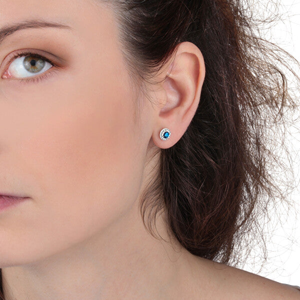 Close-up of woman wearing LA PETITE STORY JEWELRY Mod. LPS02ARQ15 earring with blue gemstone detail.
