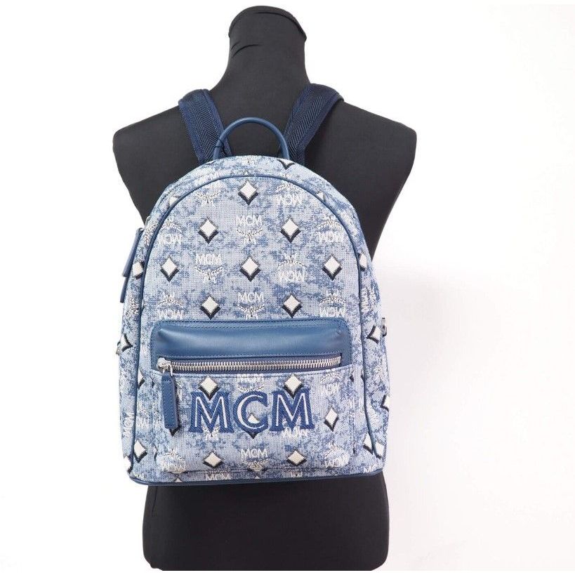 MCM Stark Small Blue Vintage Jacquard Monogram Logo Fabric Backpack Bookbag with top handle and adjustable straps.