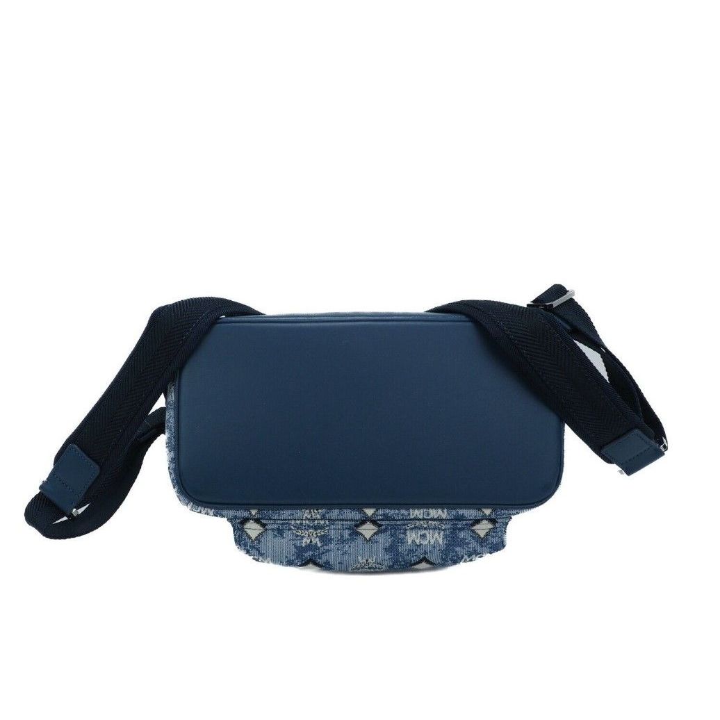 Back view of MCM Stark Small Blue Vintage Jacquard Monogram Logo Fabric Backpack Bookbag with adjustable straps.