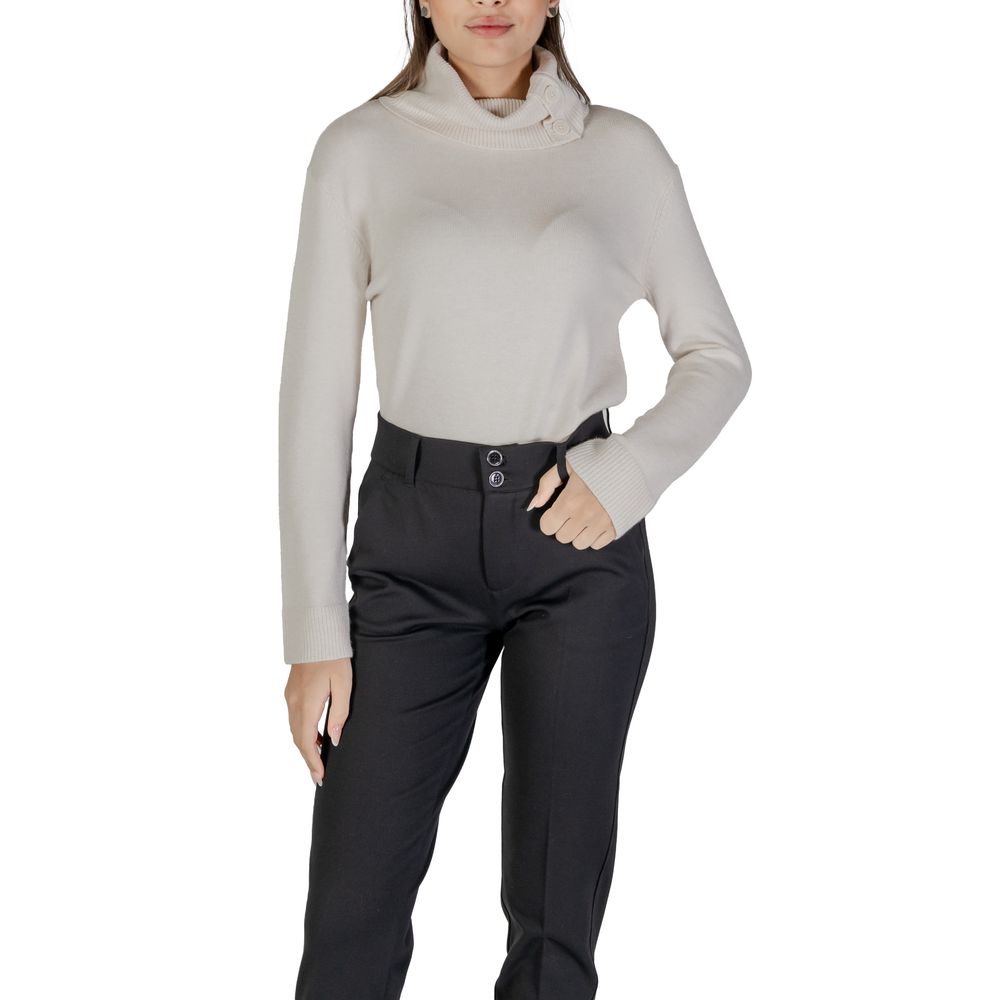 Woman wearing Street One Cream Viscose Turtleneck with stylish buttons and high neck, paired with black pants.