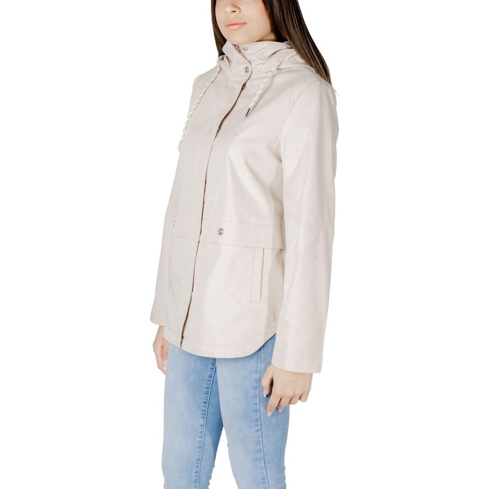 Woman wearing Street One beige parka jacket, 69% cotton, 31% polyester, with front pockets and adjustable hood for cozy style.