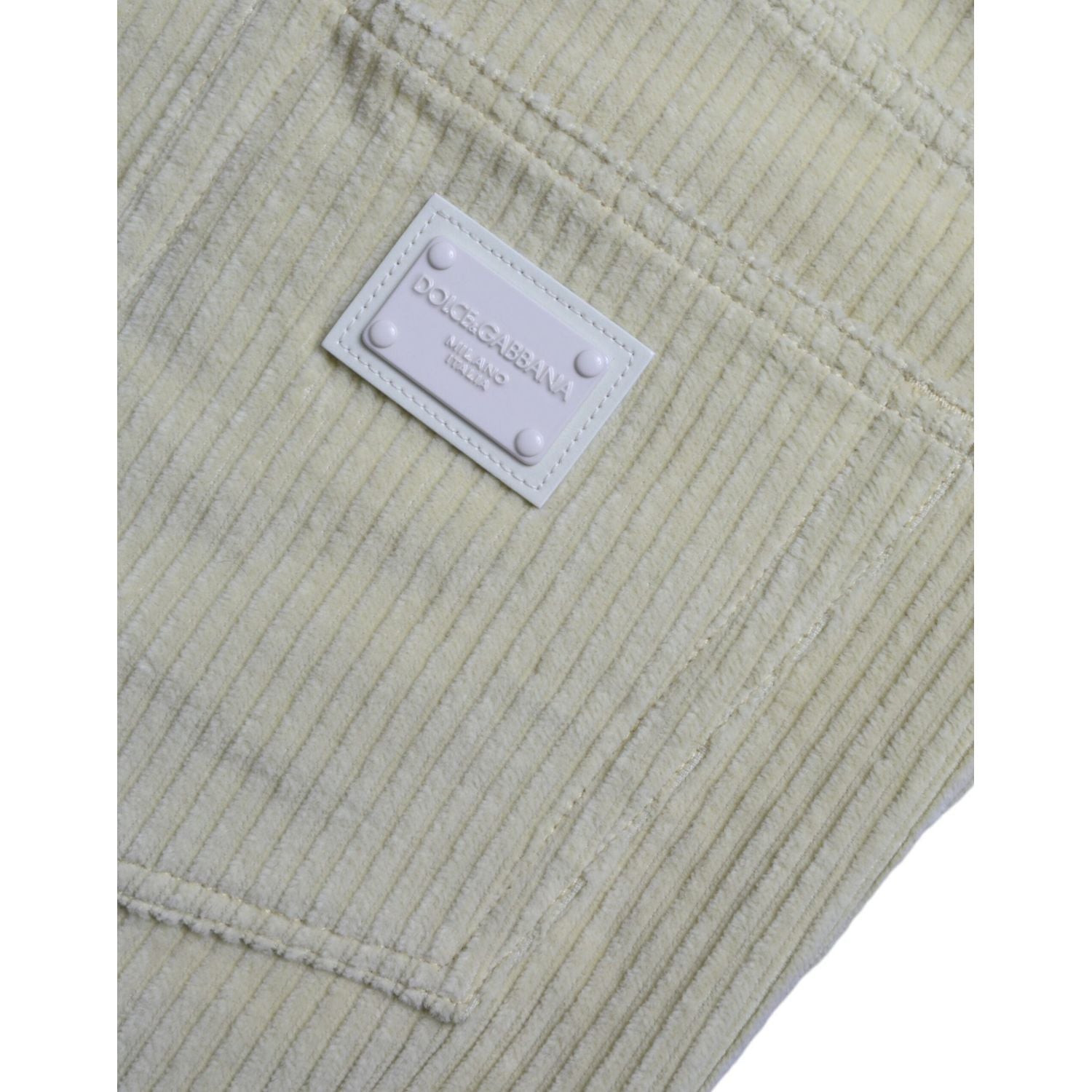 بنطلون جينز ضيق من قماش مخملي أصفر اللون مزين بشعار دولتشي آند غابانا