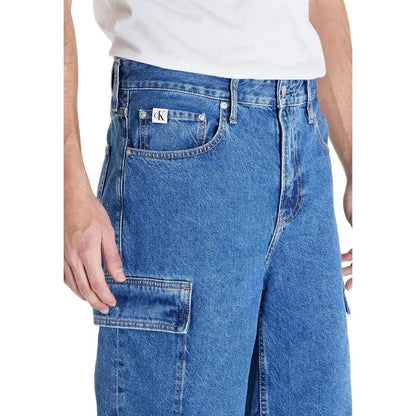 Model wearing Calvin Klein Jeans Blue Cotton Bermuda Shorts with flap side pockets, showcasing 90's loose fit style for a relaxed look.