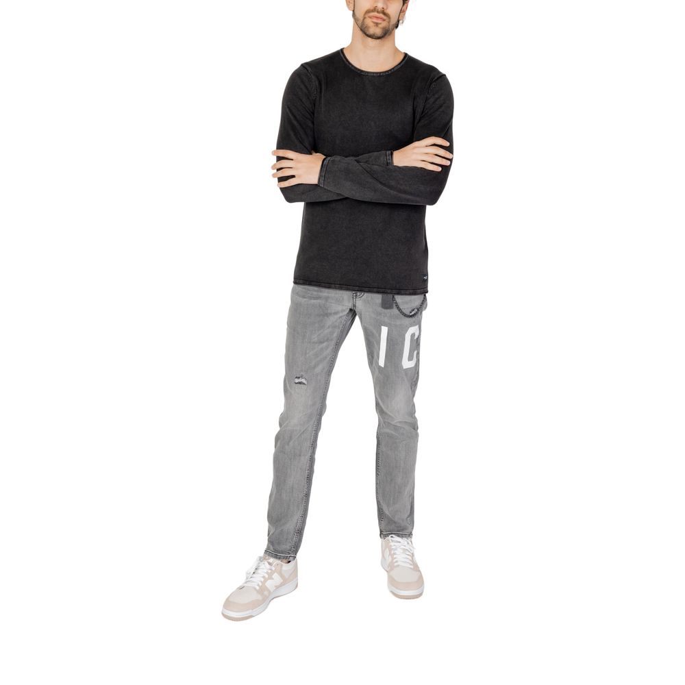 Man wearing Jack Jones Black Cotton Sweatshirt, styling casual outfit with gray jeans and sneakers, perfect for everyday wear.