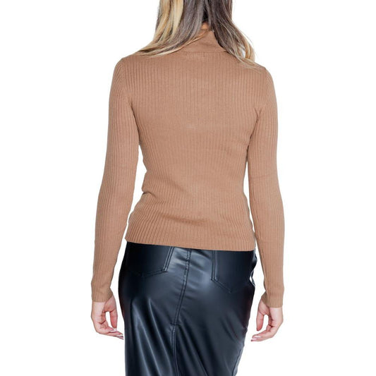 Back view of woman wearing Jacqueline De Yong brown viscose knit top, fall/winter collection, paired with black faux leather skirt.