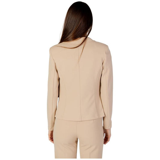 Back view of a woman wearing a Rinascimento beige polyester blazer and pants, part of the autumn/winter collection.