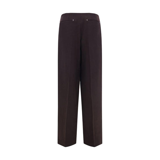 Back view of brown Fendi virgin wool pants with button and zipper closure, featuring side slash and rear welt pockets.