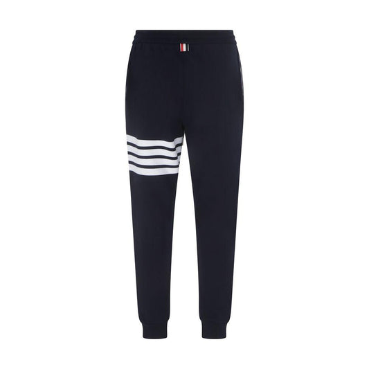 Thom Browne cotton sweatpants, elastic waistband, adjustable drawstring, white bands on left leg, back brand patch, jogger style.