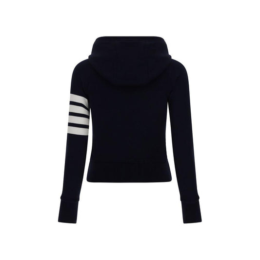 Back view of Thom Browne cotton hoodie with striped print on left sleeve, featuring adjustable drawstring and ribbed cuffs.