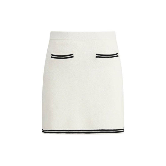 Self-Portrait midi skirt with elastic waistband, jacquard weave, tone-on-tone bows, contrast hemline, and front welt pockets.