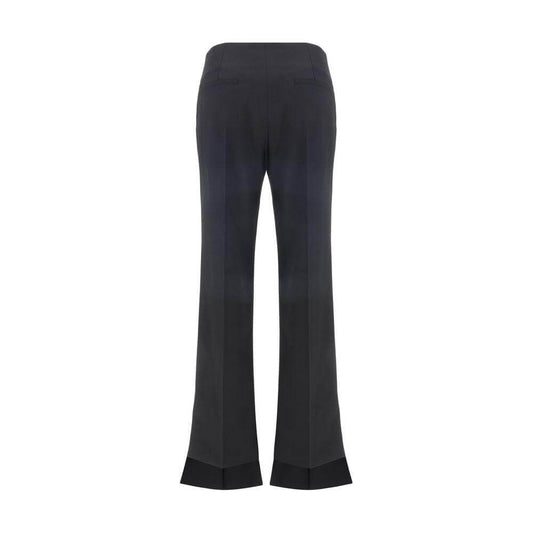 Back view of Chloé Virgin Wool Pants with asymmetrical hems and monochrome pattern, featuring two back welt pockets, regular fit.