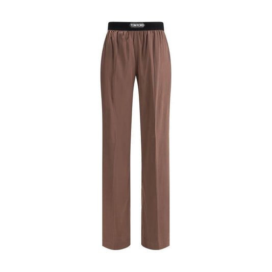 Tom Ford silk pants with elastic waistband, front slash pockets, and rear patch pockets; logo on waistband.