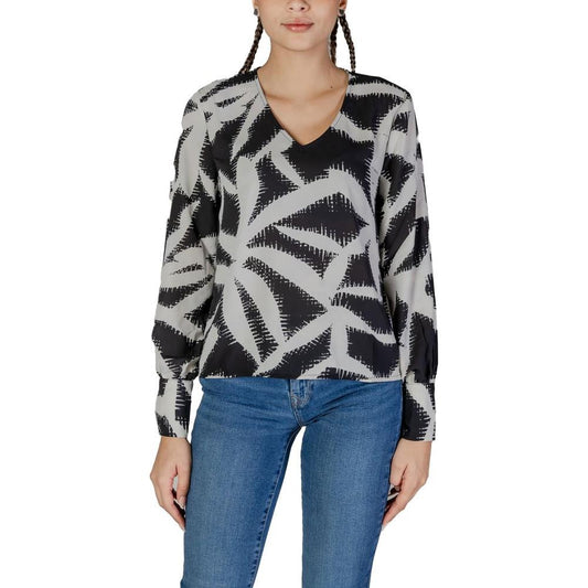 Woman wearing Jacqueline De Yong black recycled polyester long-sleeve blouse with fall-winter pattern.