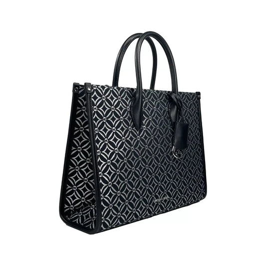 Michael Kors Mirella Medium Tote in black leather with patterned design, featuring adjustable crossbody strap and zip closure.