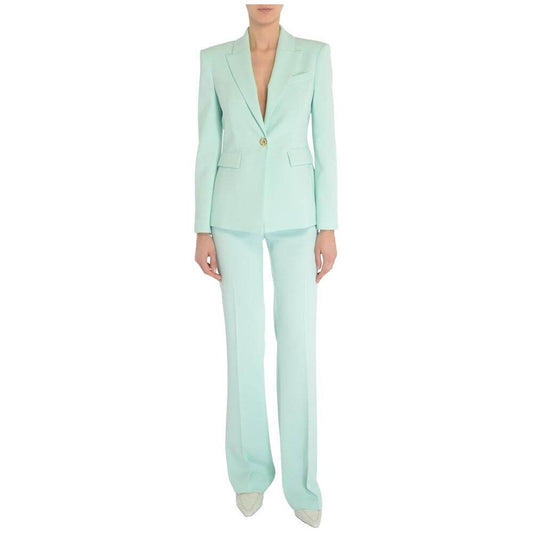 Woman in light blue PINKO pant suit; elegant style.