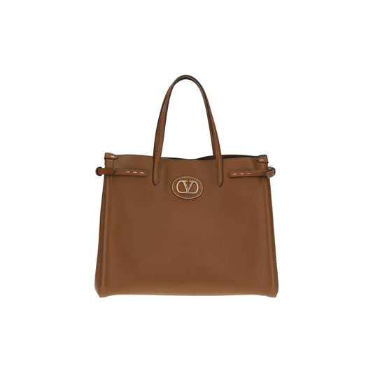Valentino Garavani Antibes Handbag in brown leather with metallic logo, side buckles, and gold finish details. Elegant and sophisticated design.