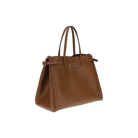 Valentino Garavani Antibes Handbag in brown leather with gold-finish metallic logo and side buckles, showcasing elegance and functionality.