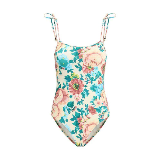 Chloé floral-print one-piece swimsuit with knotted shoulder ties and gold charms, featuring a vibrant and elegant design for summer.