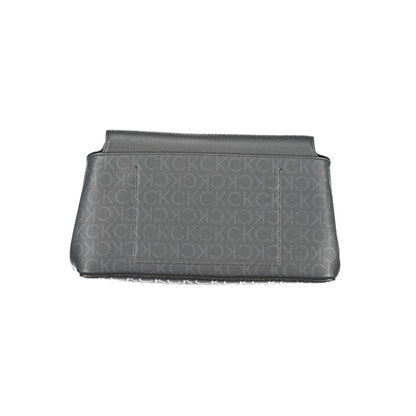 Calvin Klein Black Polyester Handbag with adjustable shoulder strap and internal pocket. Features contrasting details and snap closure.