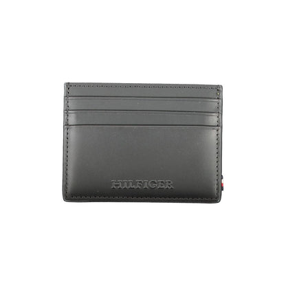Tommy Hilfiger Black Leather Wallet with card holder, central pocket, spaces for cards, contrast details, and logo.