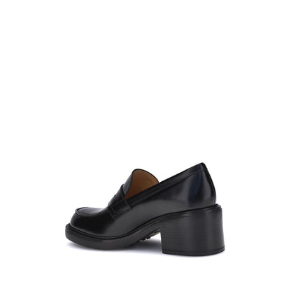Side view of Tod's Black Calf Leather Bos Taurus Platform Loafers with chunky heel, showcasing elegant and contemporary design.