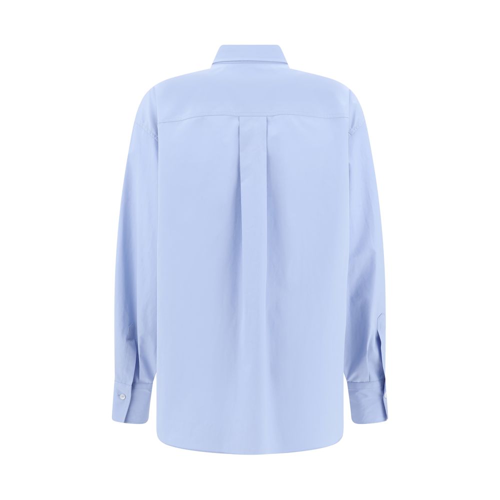 Back view of Brunello Cucinelli Light Blue Cotton Dress Shirt with classic collar and buttoned cuffs, featuring a pleated design, AW25.