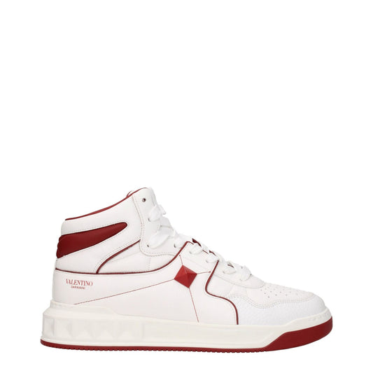 Valentino Garavani White Leather High Top Sneakers with red accents and lace-up closure, featuring studs and logos