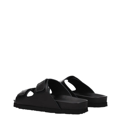 Palm Angels Black Leather Slippers with open toe and rubber sole, featuring strap closure and front logo. Casual style, low flat heel.