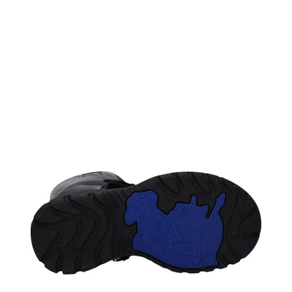 Sole view of Burberry Black Leather Boots with blue and black rubber design, round toe, mid heels for casual wear.