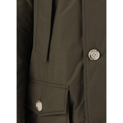 Close-up of Woolrich Green Cotton Parka with buttons and side pocket, showcasing craftsmanship and design details for AW25.