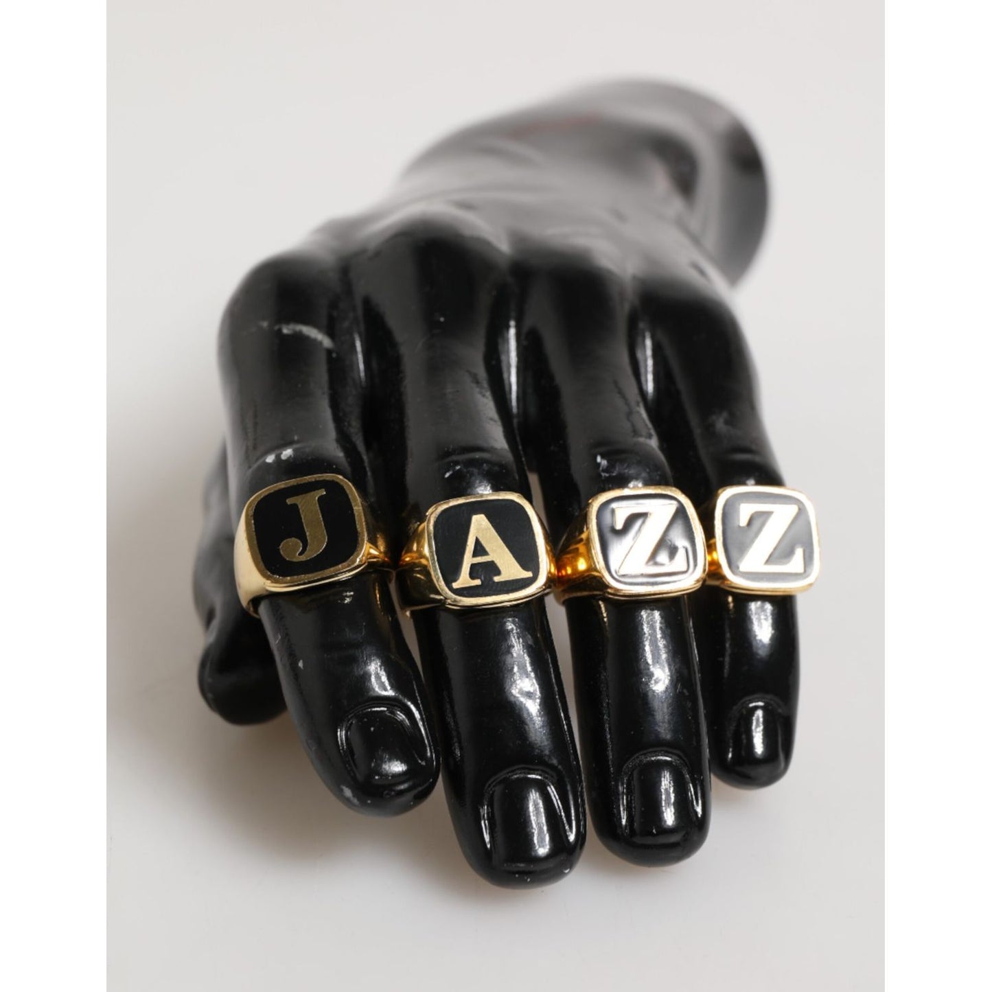 Dolce & Gabbana Gold Tone Brass JAZZ Letter Set 4 Pieces Adjustable Ring on display