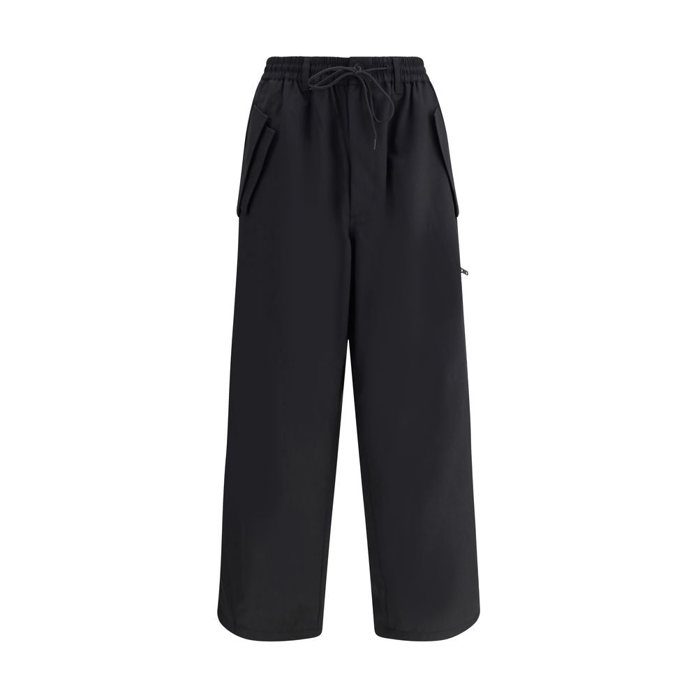 Y-3 Black Wool Casual Pants with elastic waistband and asymmetrical cuffs, showcasing urban style and functionality with multiple pockets.