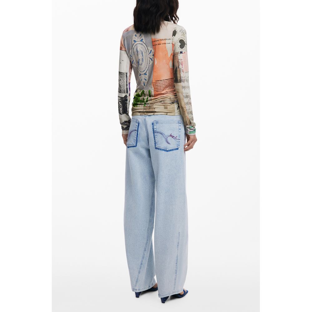 Desigual Beige Viscose Women Top with graphic back design, long sleeves, paired with light blue denim jeans, highlighting bold fashion flair.