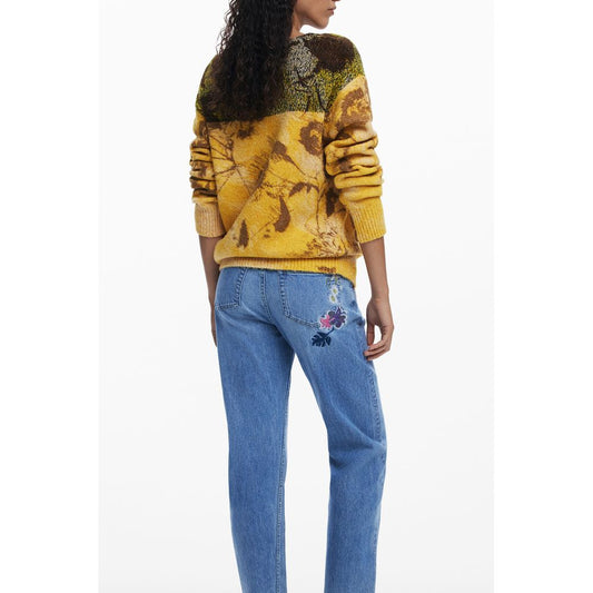 Fashion-forward model wearing Desigual Yellow Wool Women Sweater with floral pattern, long sleeves, and crew neck, perfect for bold style.