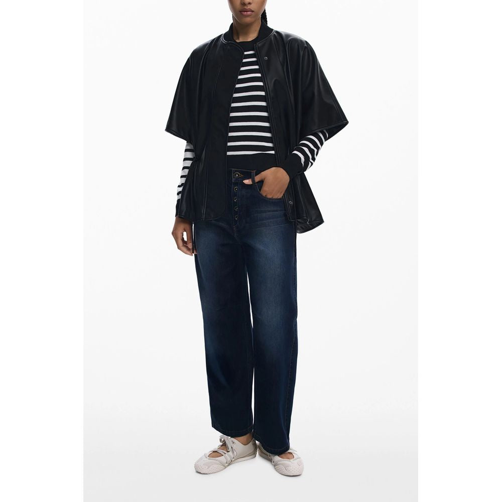 Model wearing Desigual Black Polyethylene Women Poncho with drawstring waist and embossed print, styled with striped top and jeans.