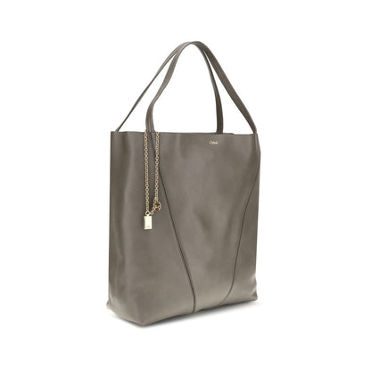 Chloé Gray Calf Leather Bos Taurus Shoulder Bag with minimalist design and hanging chain detail, ideal for versatile style and elegant occasions.