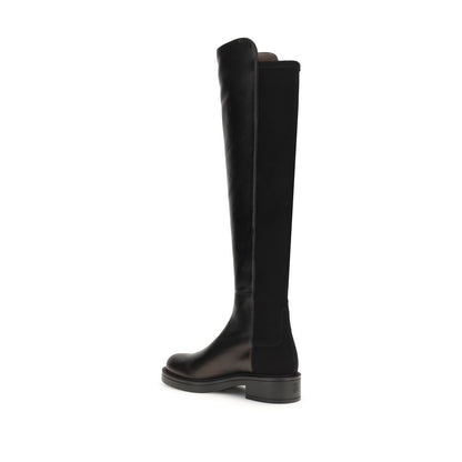 Stuart Weitzman Black Leather Over The Knee boots, side view showcasing block heel and smooth leather with elastic back, AW25 collection.