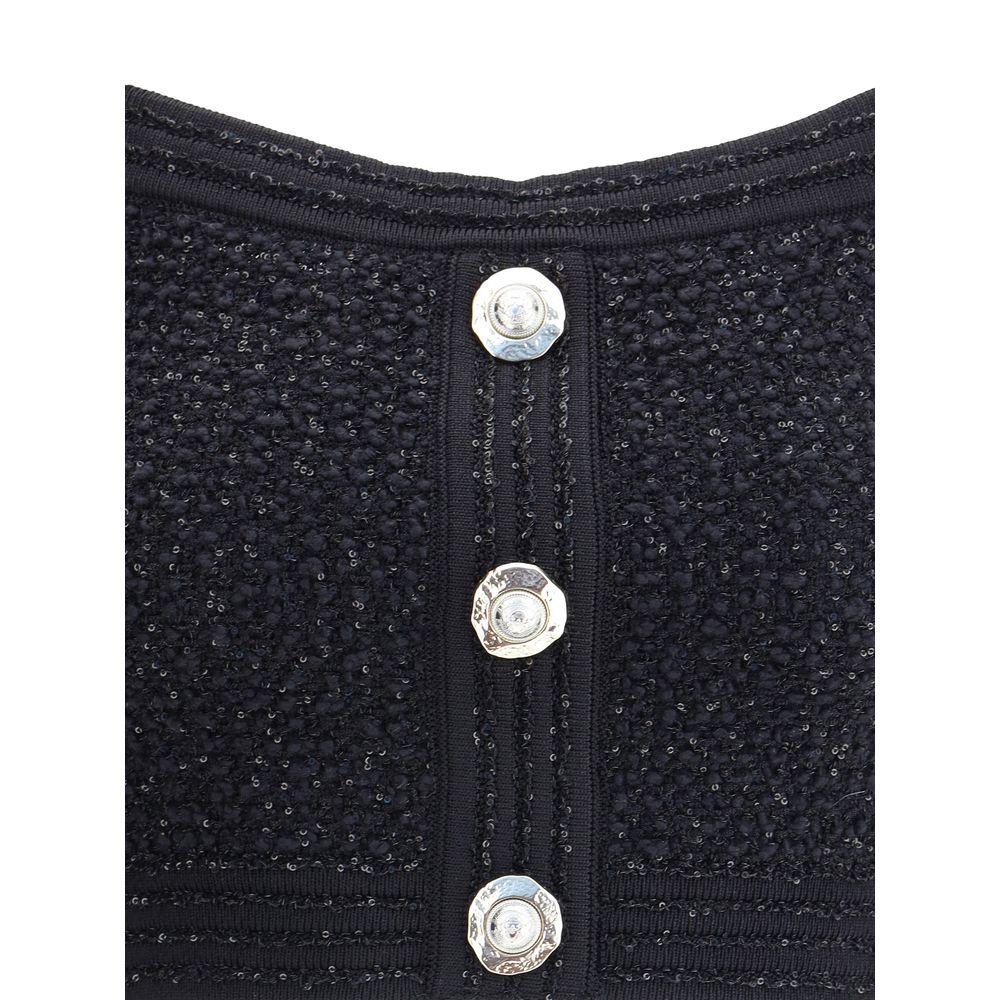 Close-up of Balmain Black Polyamide Top with embossed buttons on tweed fabric, showcasing elegant detail and design.