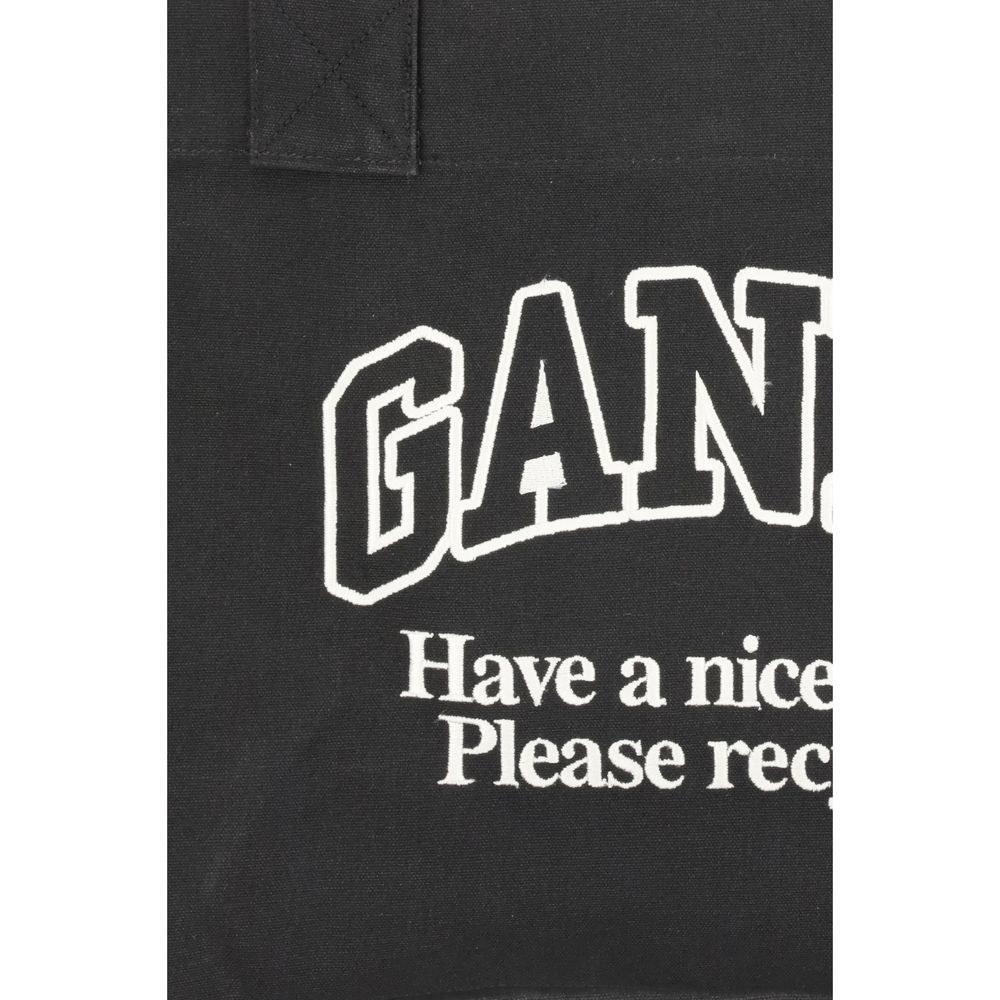 Close-up of Ganni Black Cotton Shoulder Bag with logo and recycling message