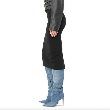 Side view of model wearing PINKO Black Viscose Skirt with rear slit, paired with jacket and denim boots, showcasing slim fit design.