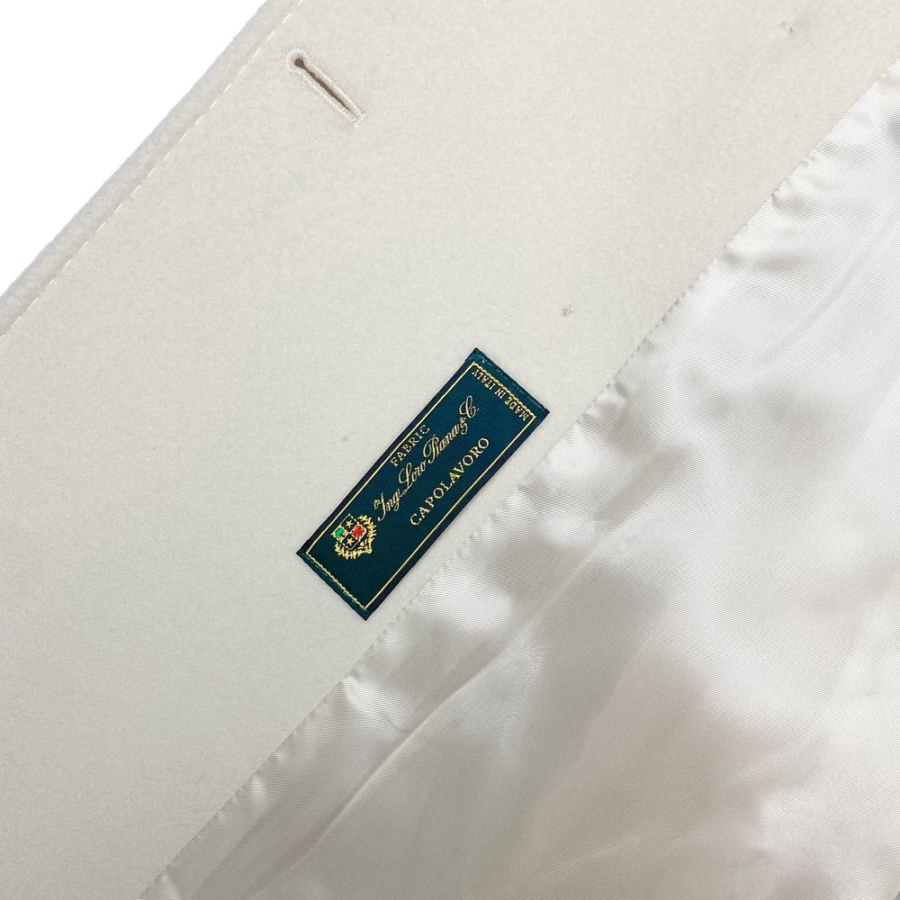 Label of Made in Italy White Wool Women Coat made with Loro Piana fabric showing luxury craftsmanship and quality.