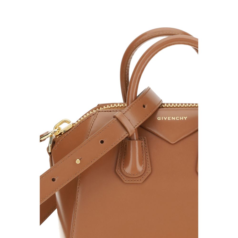 Close-up of Givenchy Brown Calf Leather Bos Taurus Handbag with strap, showing shiny leather and iconic monogram design.