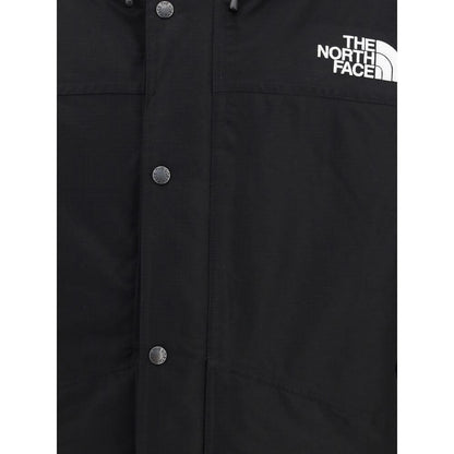 The North Face Black Polyester Coat featuring front buttons and logo displayed, ideal for harsh weather protection and comfort.