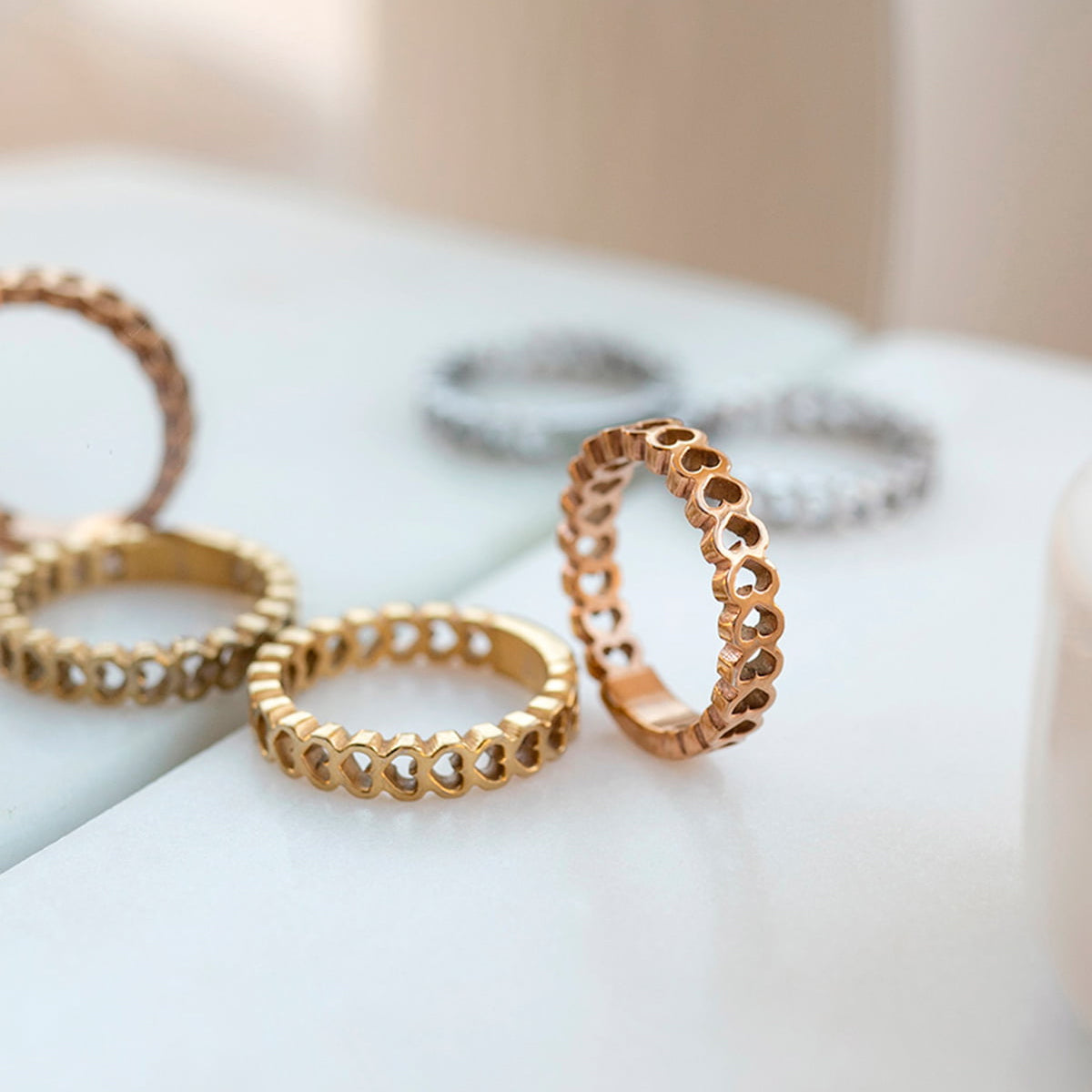 AN JEWELS JEWELRY Mod. AL.RSC01SYR-9 heart design rings in gold and silver on white surface