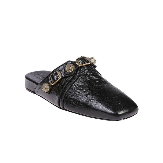 Balenciaga Cozy Cagole leather mules in black with silver studs, buckle detail, square toe, slip-on design, and flat sole.