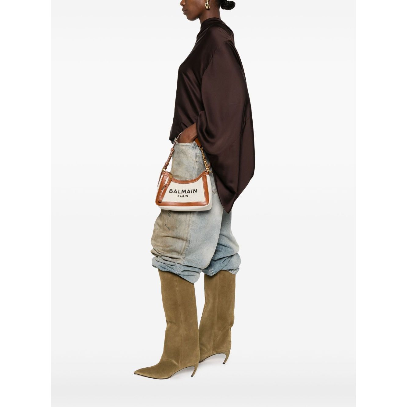 Model wearing Balmain B-Army canvas shoulder bag with beige top zip, detachable handle, and embroidered logo.