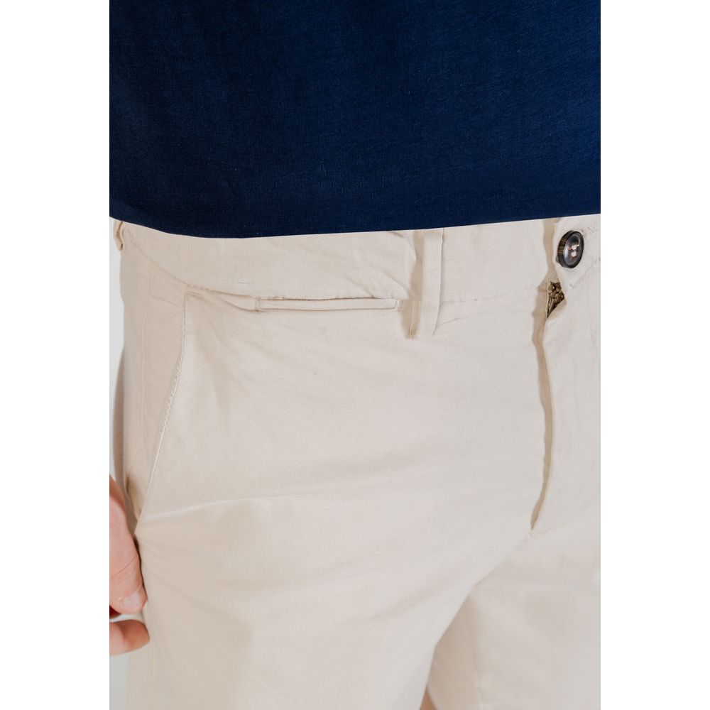 Close-up of Borghese Bicolor Cotton Bermuda Shorts in beige, showcasing button and pocket details on a model.